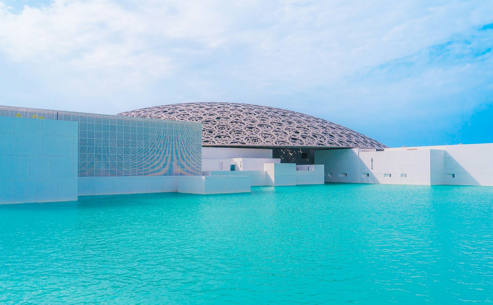 Turquoise waterfront and the Louvre Abu Dhabi dome on Saadiyat Island